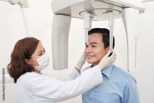 Man taking dental tac with cephalometric panorama x-ray machine in clinic photo