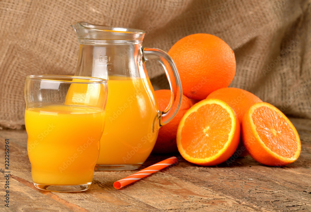 Premium Photo  Orange juice in pitcher and oranges.