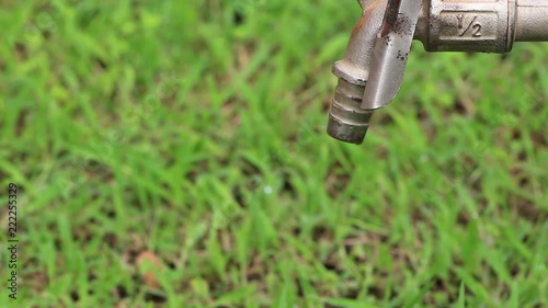 HD video footage showing water dripping from a metallic tap faucet