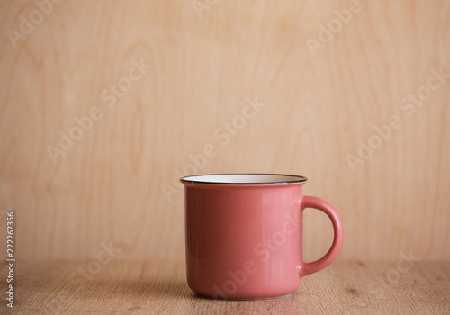 Pink Coffee Mug on Wooden Background. Isolited. Copy Space photo