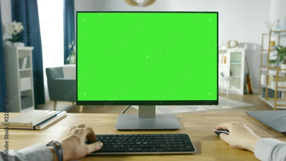 First Person View of Professional Freelancer Working on Green Mockup Screen Personal Computer From Home. Man Types, Browsing Through the Internet, Using Computer In the Comfort.