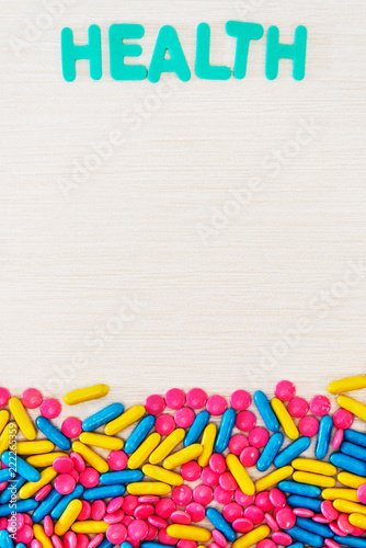 The word letters Health and various medication and pills