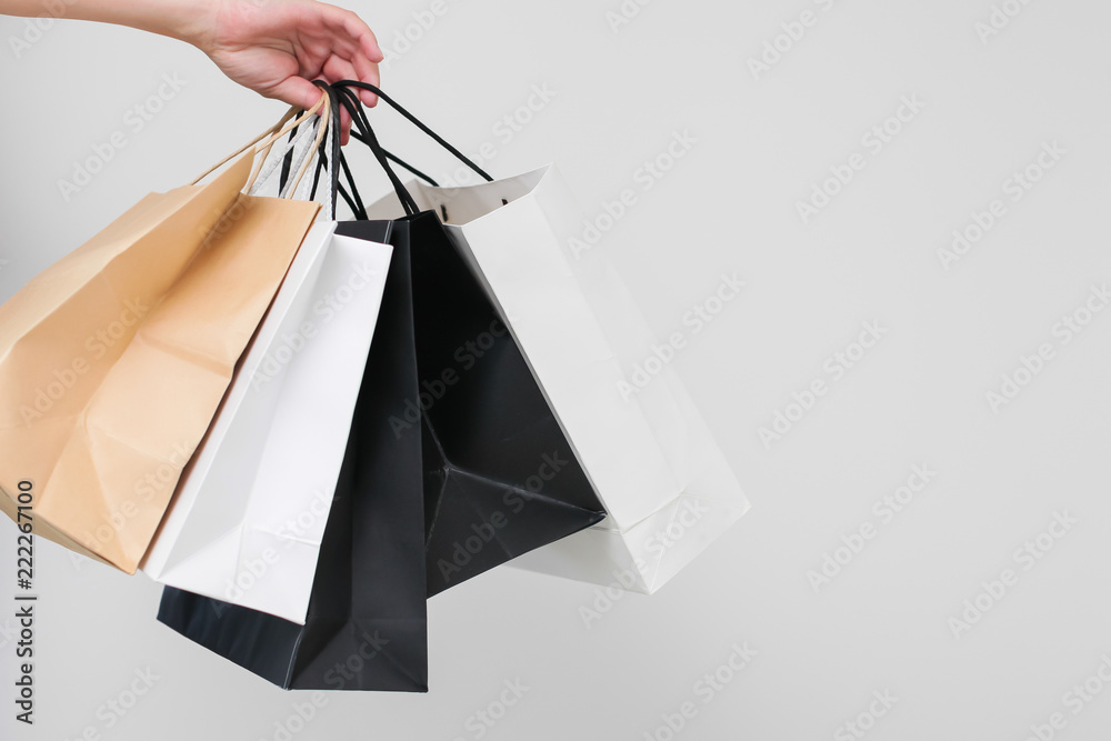 female hand with shopping bags on white background isolated
