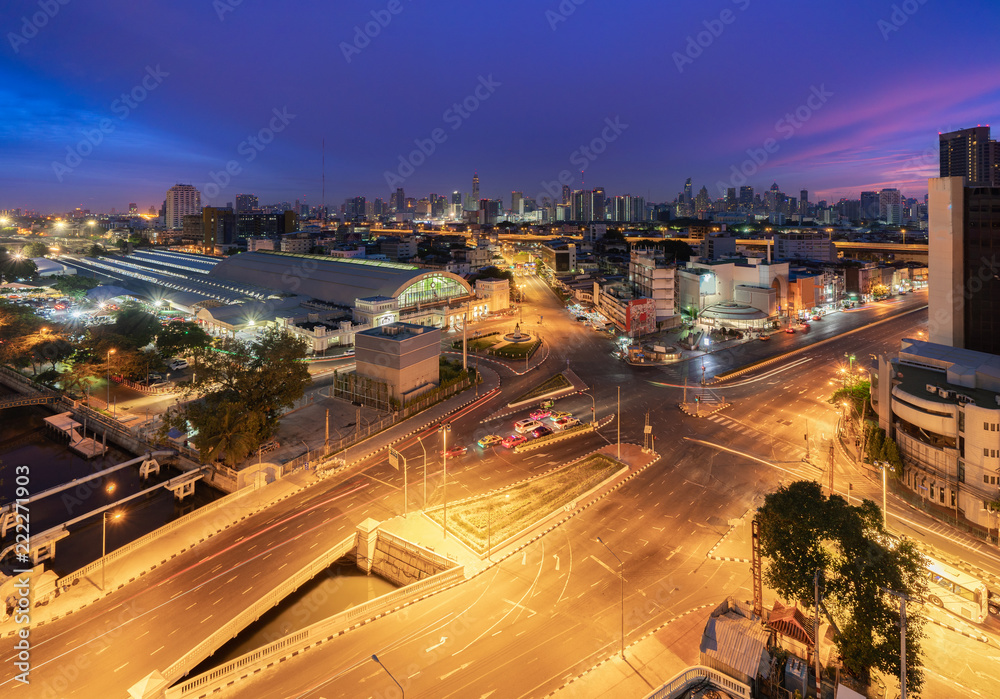 Fototapeta premium Aerial View of Bangkok Train Station or Hua Lamphong Railway Station in Blue Hour. Bangkok City with Car Traffic Light Trial at Twilight Time.