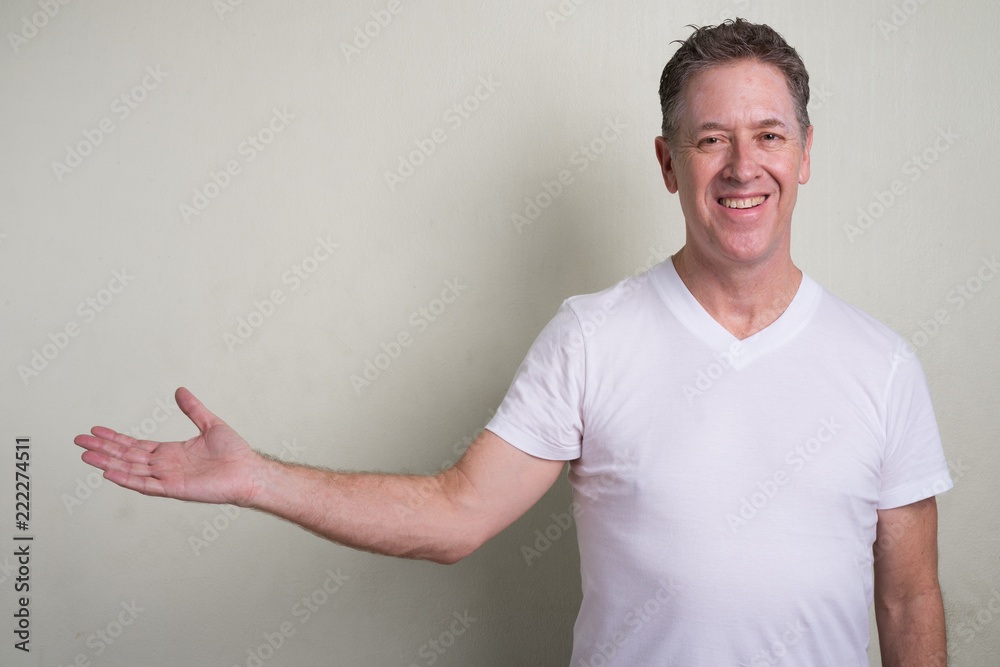 Portrait of mature man with gray hair against white background