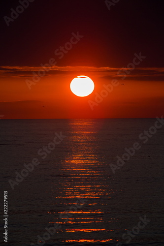 baltic seaside with red sun goes down