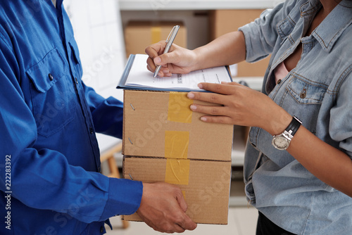 Worker man delivering the boxes to woman at home or office