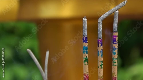 Beautiful close up shots of incense sticks with smoke in an Asian temple photo