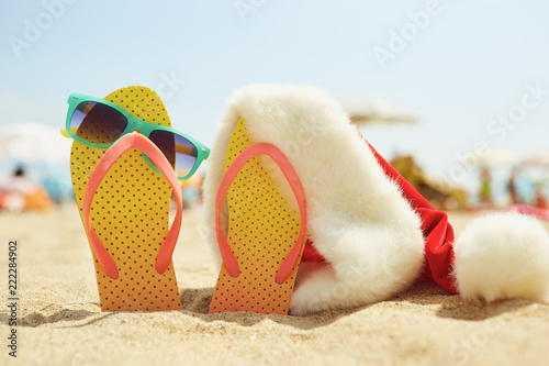 Santa's hat on the beachon Christmas Day.  The concept of celebrating Christmas in a seaside resort. photo