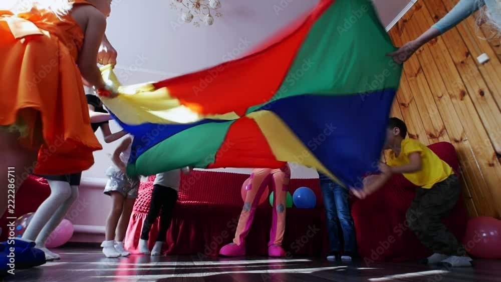 Children play and waving a colorful cloth. Children's holiday. The performance of the animators. Children play and waving a colorful cloth. Children's holiday. The performance of the animators.