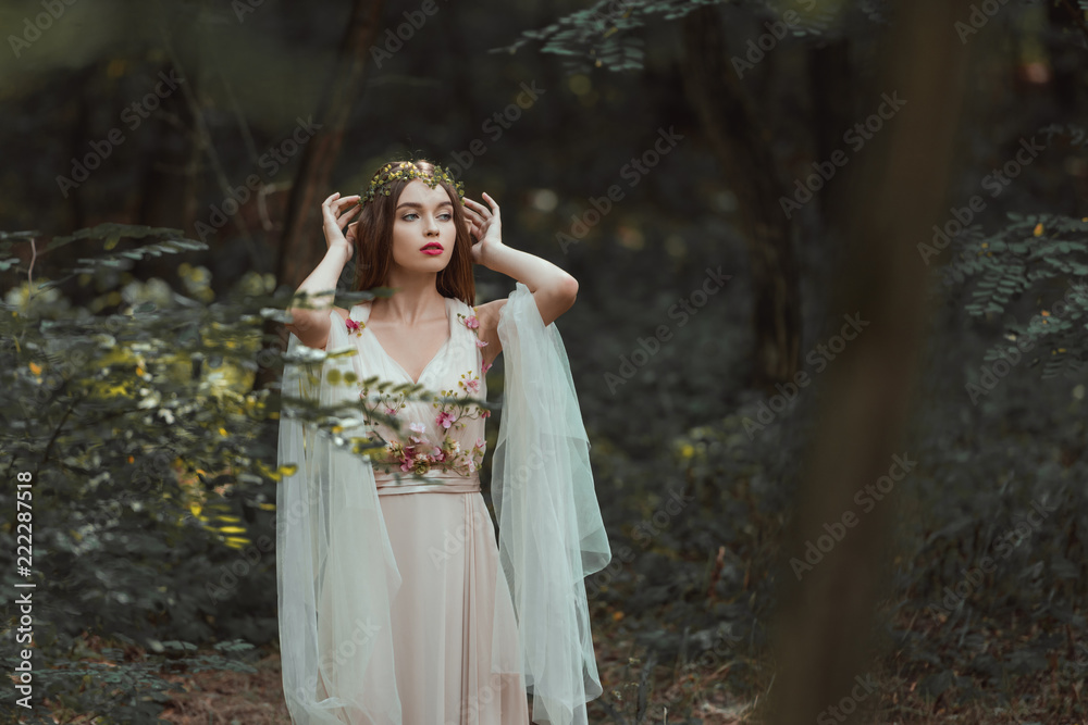 fantasy girl with elf ears in flower dress posing in forest fantasy girl with elf ears in flower dress posing in forest