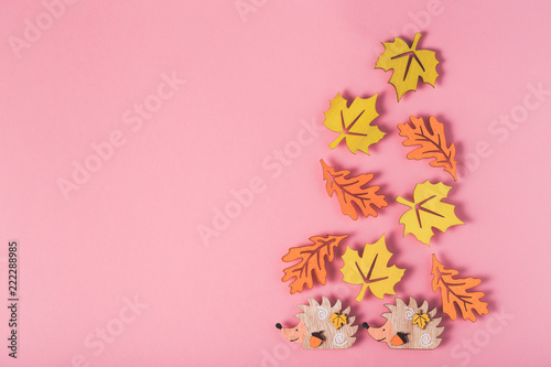 Multicolor wooden figures autumn elements like leafs and hedgehog.  Fall background with copy space. © cegli