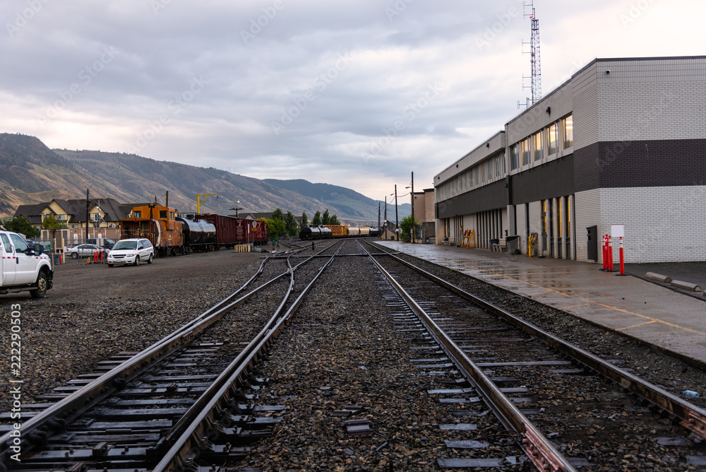 View of a Train Depot under Cloudy Sky at Sunset