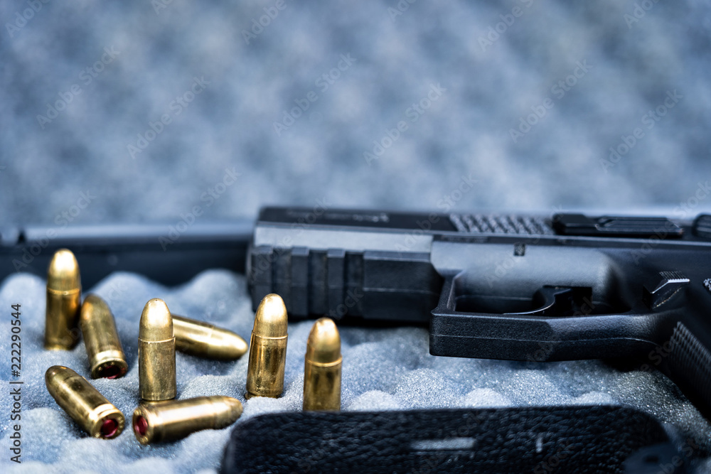 Close up view of bullets and handgun. Shallow depth of field. Focus on a pistol. Close up view of bullets and handgun. Shallow depth of field. Focus on a pistol.