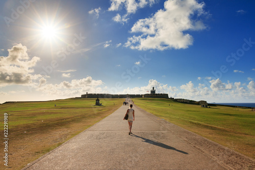 Beautiful tourist visits Fort San Felipe Del Morro in San Juan, Puerto Rico, on a summer afternoon photo