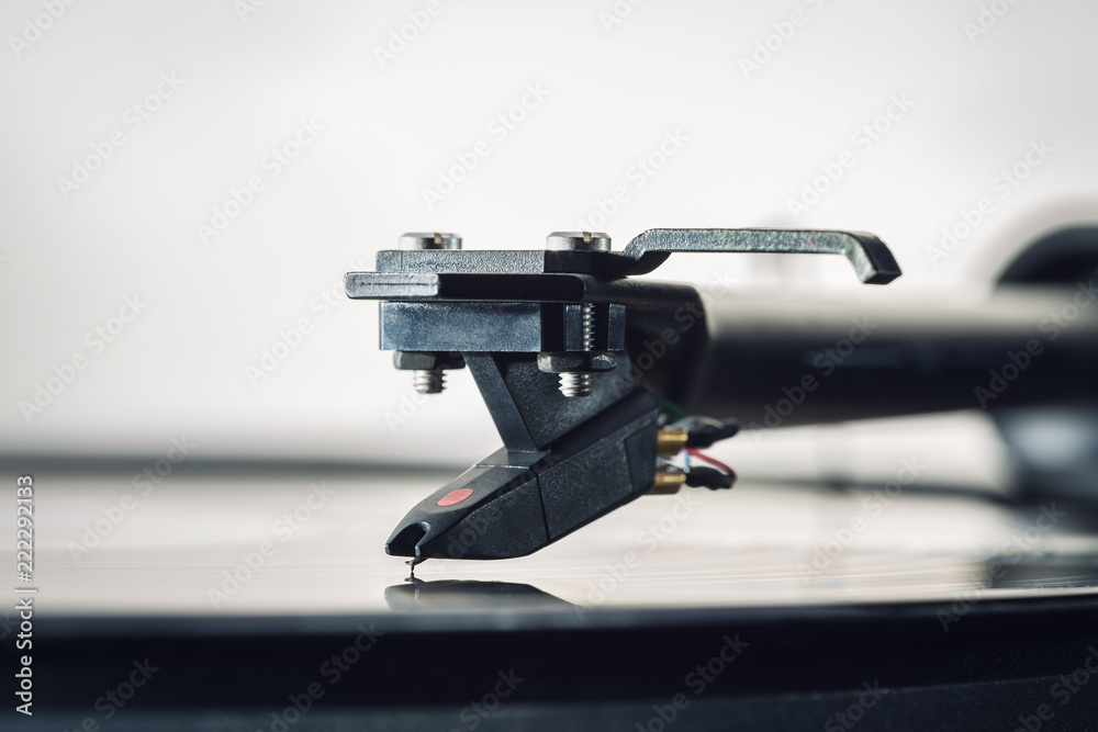 Background cartridge for vinyl records close-up. Tonearm with pickup head. Copy space. Background cartridge for vinyl records close-up. Tonearm with pickup head. Copy space.