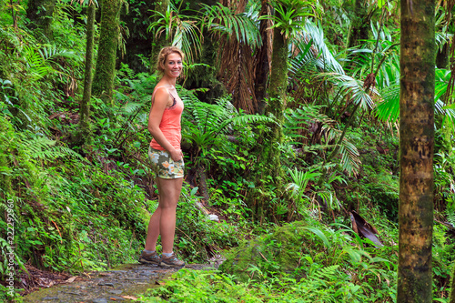 Adventurous and stunning young woman hiking in the beautiful jungle of the El Yunque national forest in Puerto Rico