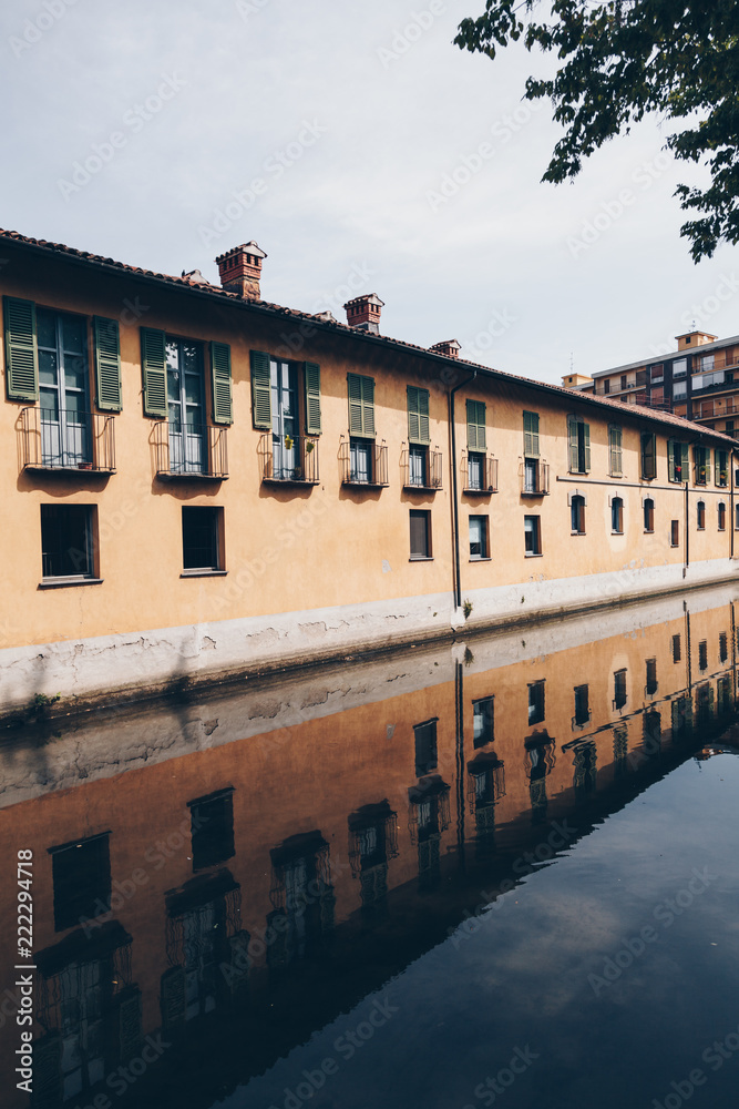 house with reflection along the Martesana canal in Milan