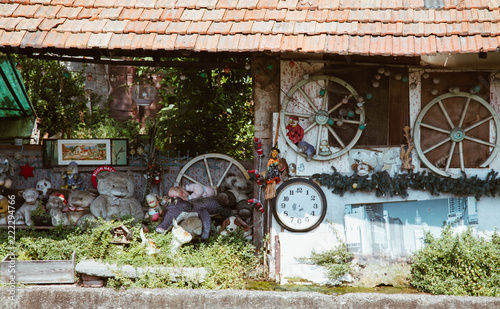 Milan ITALY - July 2018 - strange house with stuffed animal and watch in abandoned place Martesana channel Milan.