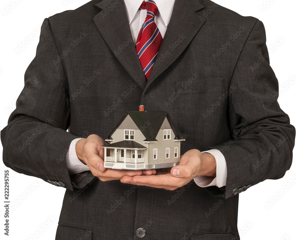 Men's Cupped Hands Holding a Model of a House - Isolated Men's Cupped Hands Holding a Model of a House - Isolated