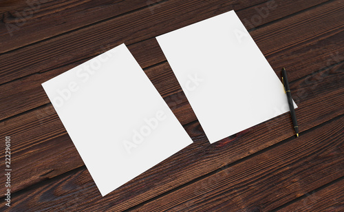 3D render of clean paper sheet. Template for your design. On wooden table.