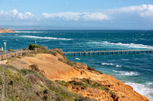 The Port Noarlunga Jetty in rough seas from the northern cliff face in South Australia on the 6th September 2018 photo