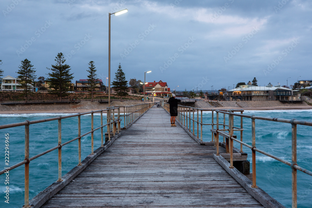 A fisherman on the Port Noarlunga Jetty looking back towards the shore at Port Noarlunga South Australia on 12th September 2018