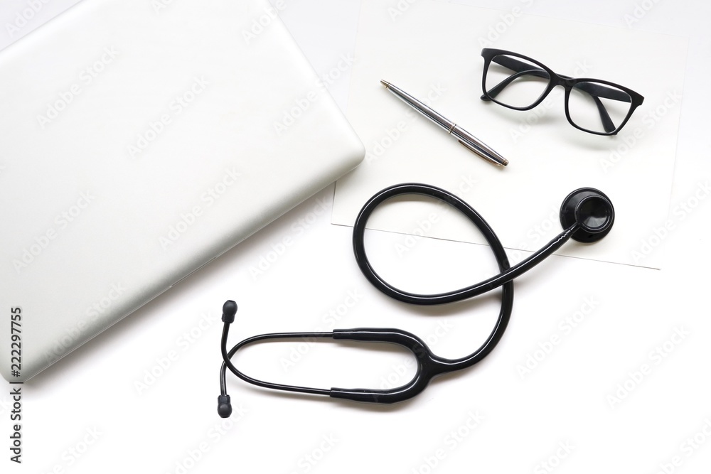 items doctor on desk , stethoscope , glasses , pen , laptop on white background items doctor on desk , stethoscope , glasses , pen , laptop on white background