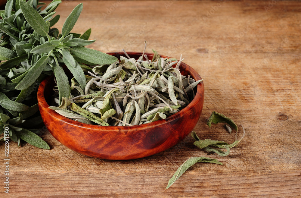 bowl with dried sage and fresh sage over wooden background bowl with dried sage and fresh sage over wooden background