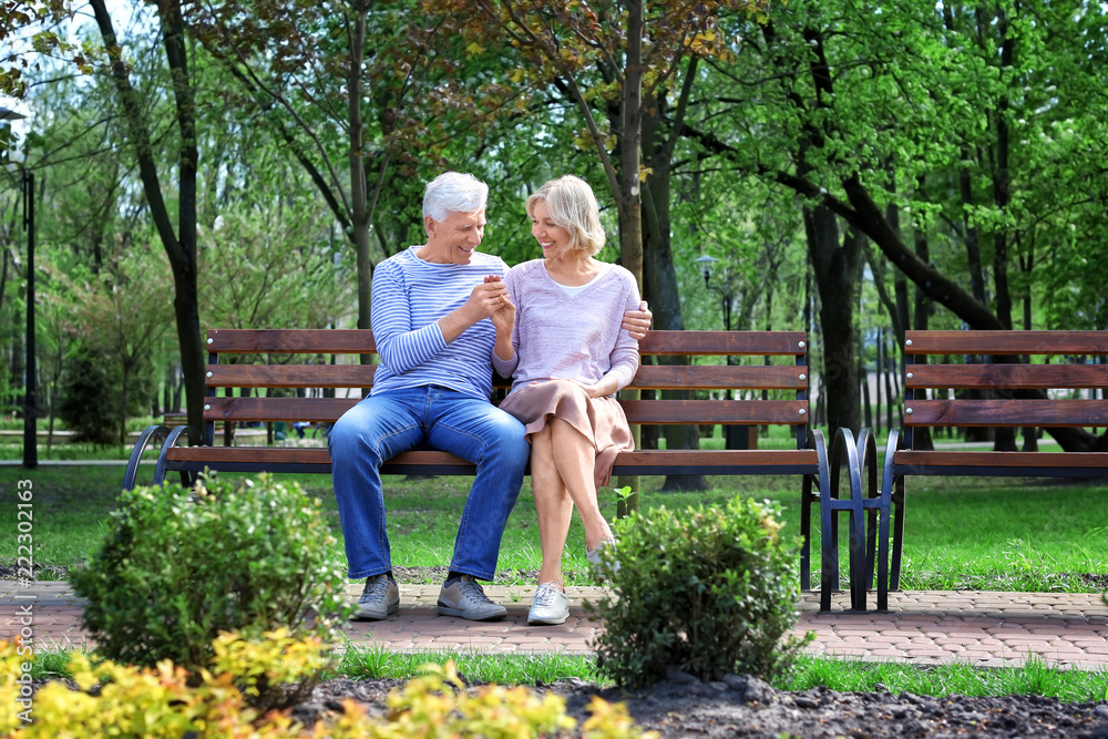 Mature couple resting in park on spring day Mature couple resting in park on spring day