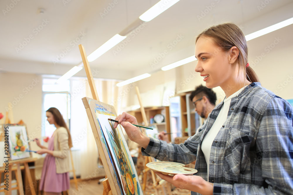 Art students painting in workshop Art students painting in workshop