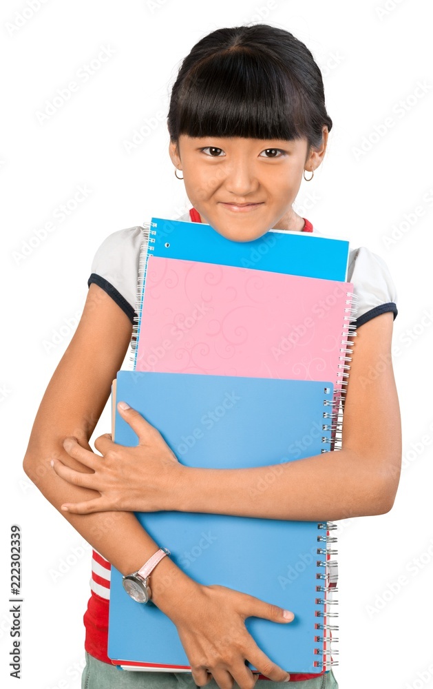 Young Asian girl wearing a backpack and carrying notebooks Young Asian girl wearing a backpack and carrying notebooks