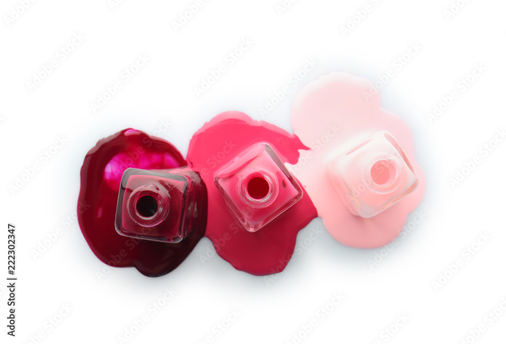 Open bottles of nail polishes on white background Open bottles of nail polishes on white background