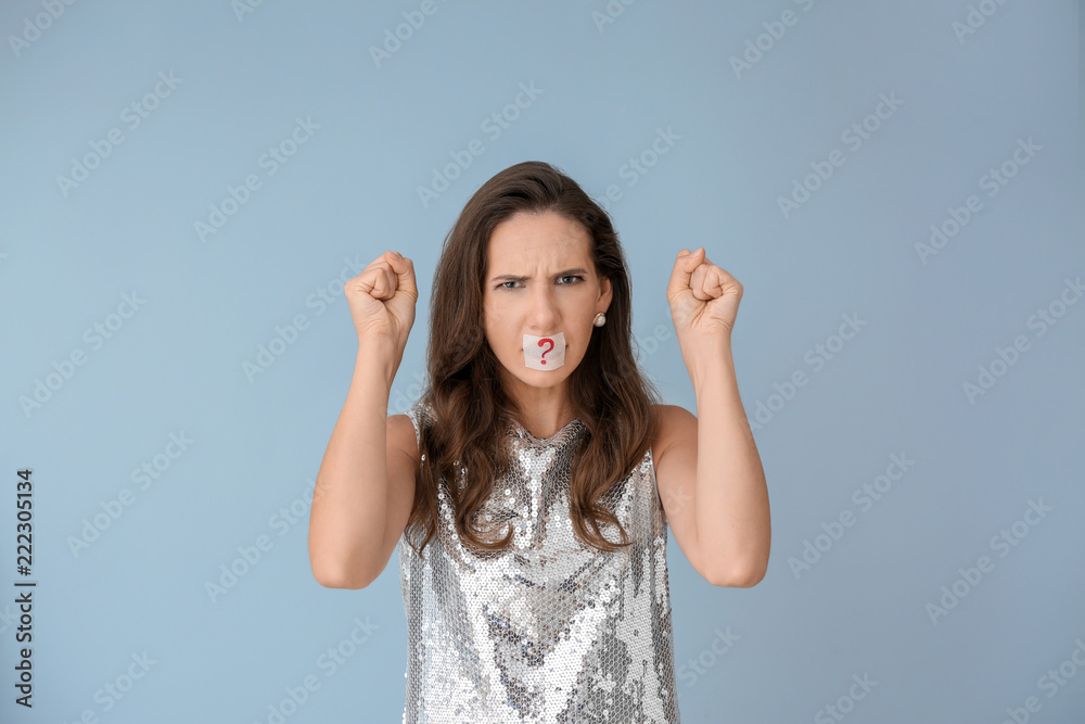 Emotional woman with taped mouth on color background. Diet concept Emotional woman with taped mouth on color background. Diet concept