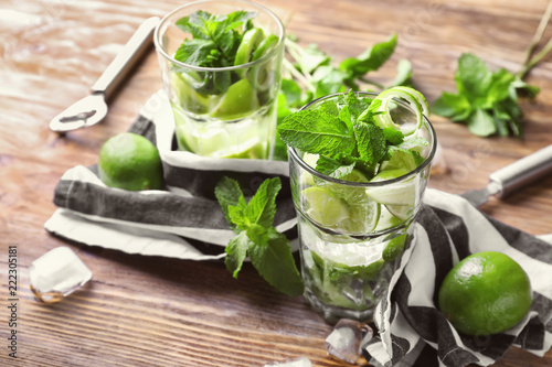 Glasses of fresh mojito on wooden table
