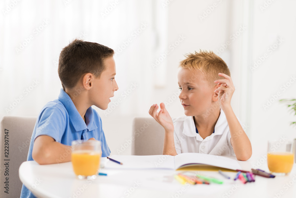 Little boys communicating while drawing together at home Little boys communicating while drawing together at home