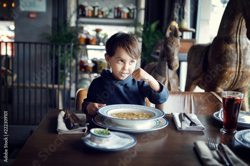 boy eating soup in the cafe