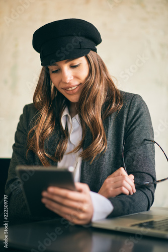 Wallpaper Mural Young modern woman sitting in cafe and using laptop. Torontodigital.ca