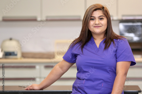 Portrait of an attractive hispanic woman healthcare professional, female nurse in medical clinic.