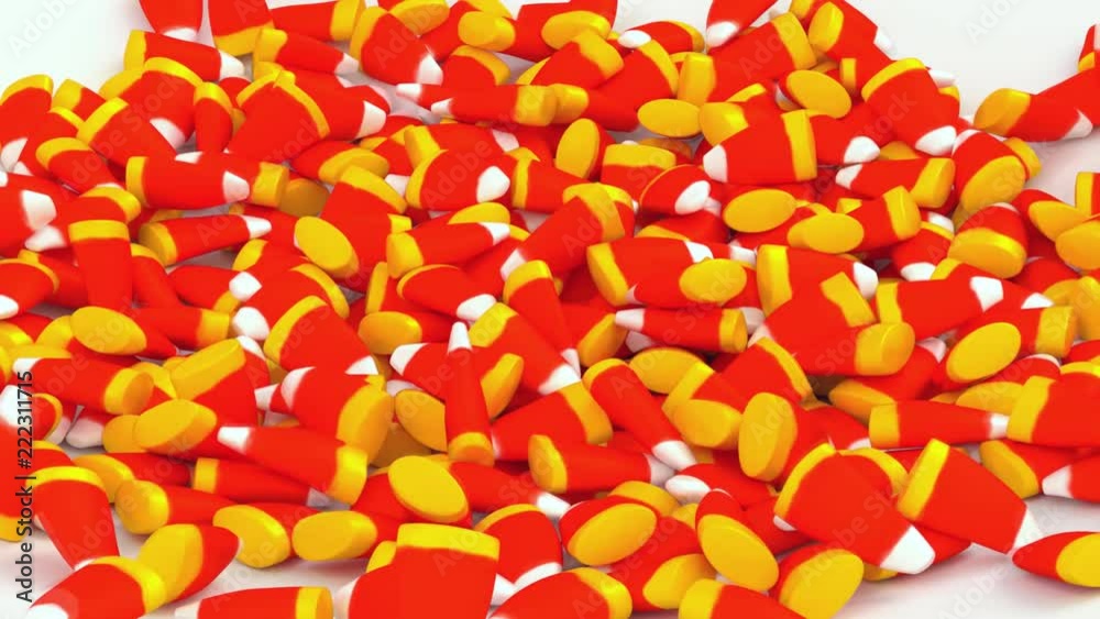 Animated high angle view of close up of Halloween white and red and yellow sugar cone candies falling onto white base bouncing and tumbling into pile.