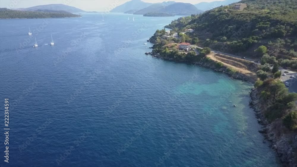 Aerial view along the shoreline. Drone view over deep blue ocean distant boats Aerial view along the shoreline. Drone view over deep blue ocean distant boats