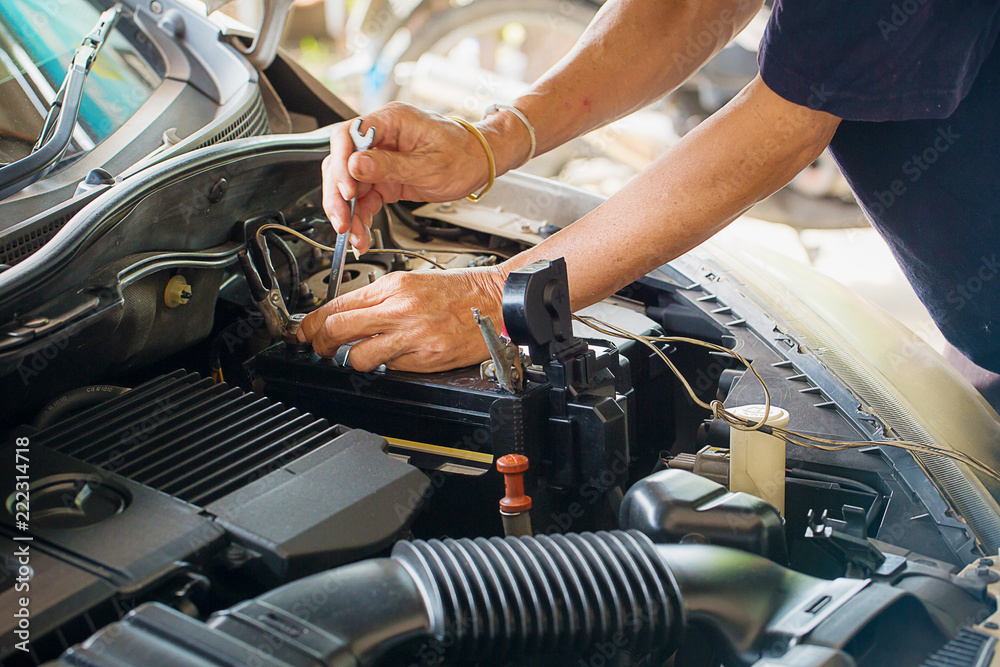 Engine engineer is replacing  car battery because car battery is depleted. concept car maintenance 