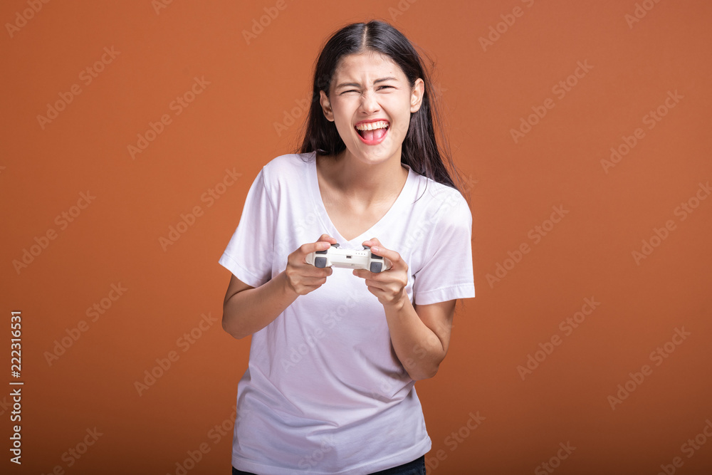 Woman gamer isolated over orange background. Woman gamer isolated over orange background.