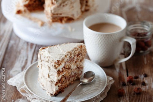 ePiece of crispy coffee and nut meringue cake with butter cream frosting