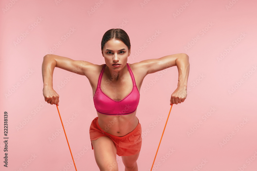 Workout. Woman Training With Resistance Bands On Pink Background Workout. Woman Training With Resistance Bands On Pink Background
