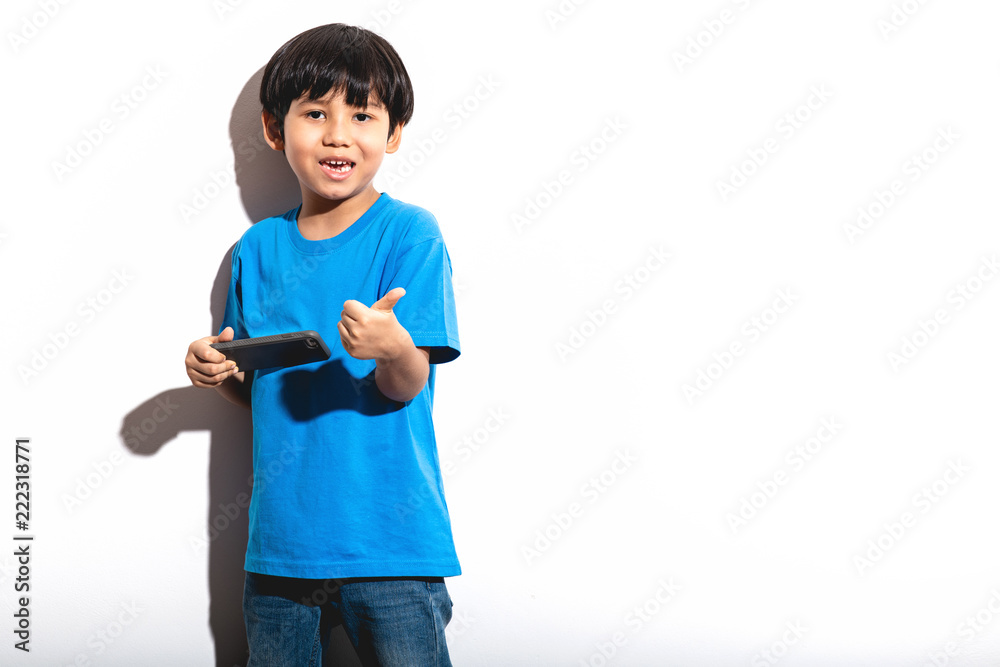 Young boy playing mobile game portrait in white background with hard light. Young boy playing mobile game portrait in white background with hard light.