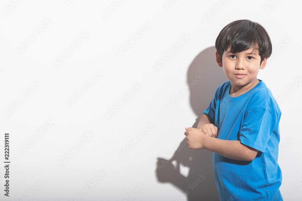 Young boy portrait in white background with hard light. Young boy portrait in white background with hard light.