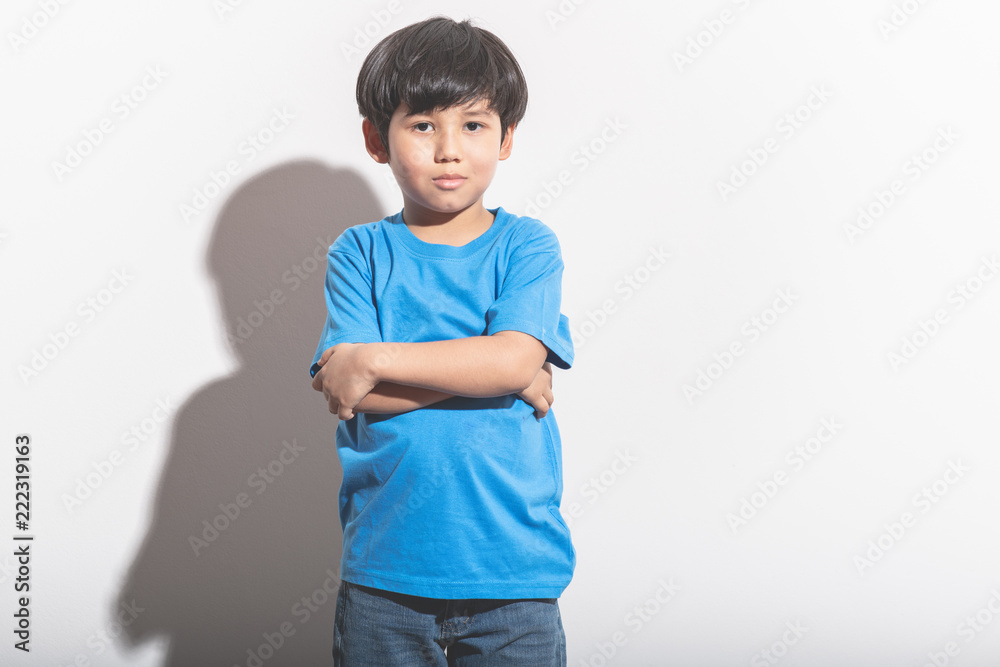 Young boy portrait in white background with hard light. Young boy portrait in white background with hard light.