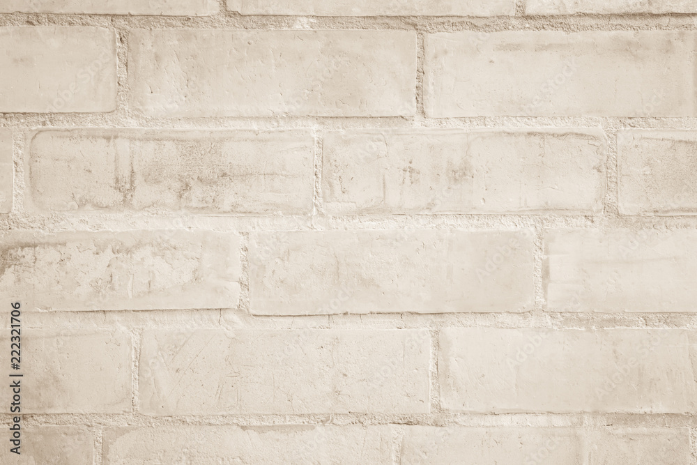 Fototapeta premium Cream and white brick wall texture background. Brickwork or stonework flooring interior rock old pattern clean concrete grid uneven bricks design stack.
