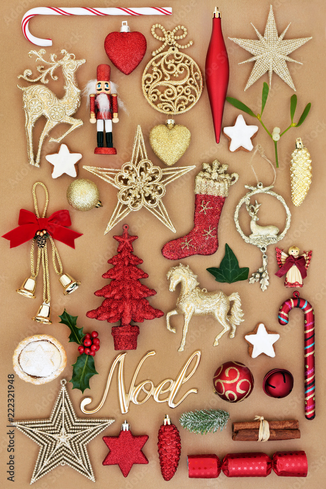 Christmas noel sign with retro bauble tree decorations and ornaments with winter flora and traditional symbols of the festive season with background of wrapping paper. Top view.